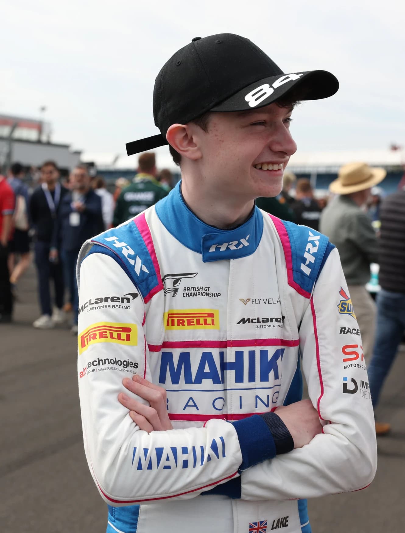 Revie Lake in Mahiki Racing overalls on the grid with the crowd behind him