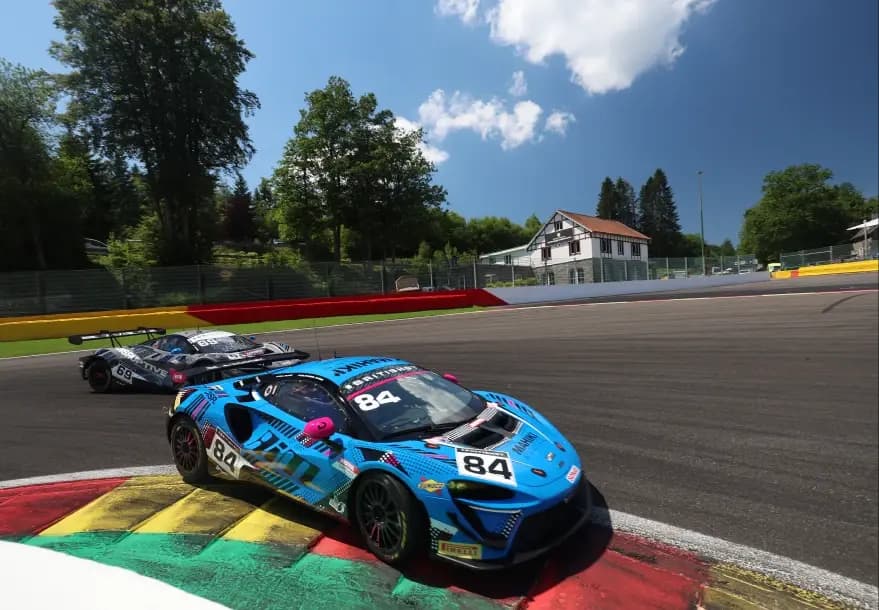 The number 84 Mahiki Racing McLaren Artura GT4 riding the red and yellow kerbs at Spa-Francorchamps
