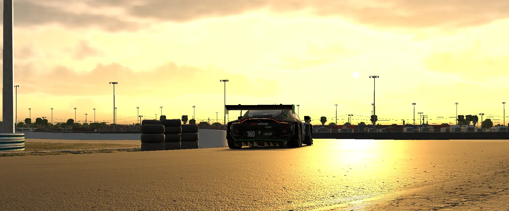 The number 360 Aston Martin Vantage GT3 running into a low sun at Sebring
