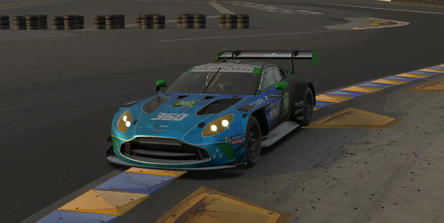 The number 360 Aston Martin Vantage GT3 cutting a kerbed chicane in low evening light